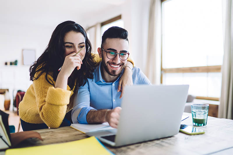 Happy Couple Looking at Computer